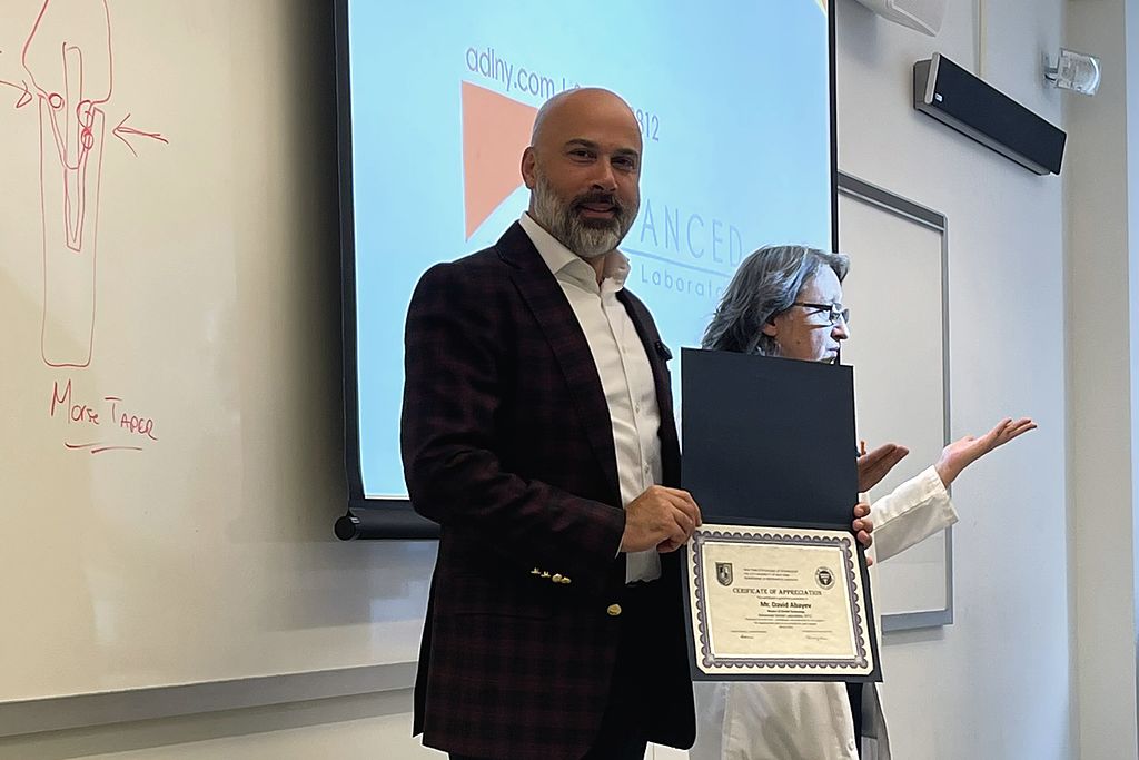 David Abayev receiving a certificate of appreciation after presenting to CUNY's graduating class