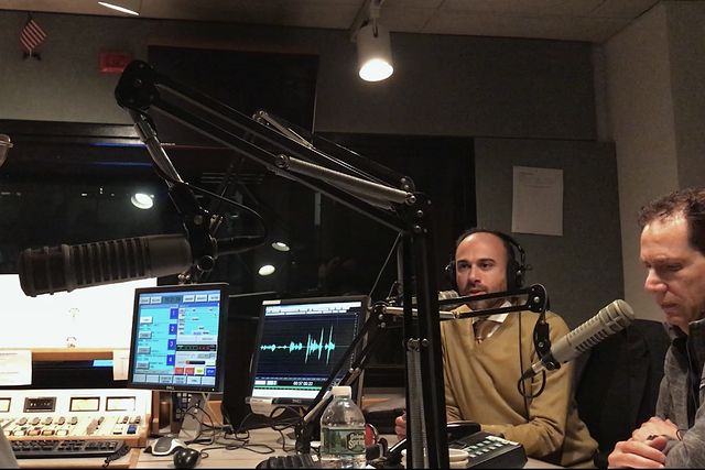 David Abayev in a radio studio with headphones and microphones during a WABC talk show